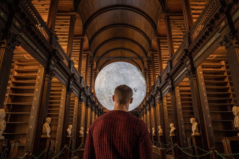 Luke Jerram's Museum of the Moon installation in the Long Room at Trinity College Dublin